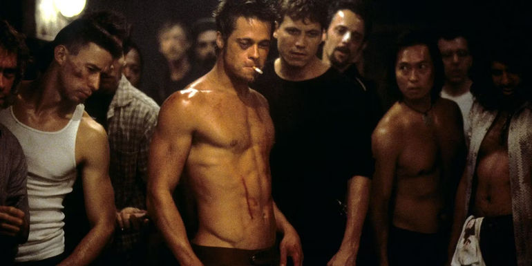A shirtless Tyler Durden (Brad Pitt) with a black eye smoking a cigarette in Fight Club