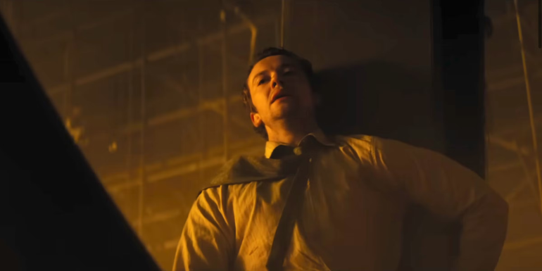 Joseph Quinn as Eric standing against a wall in A Quiet Place: Day One