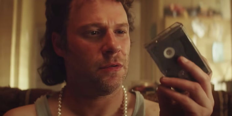Seth Rogen as Rand looking at a video tape in Pam & Tommy