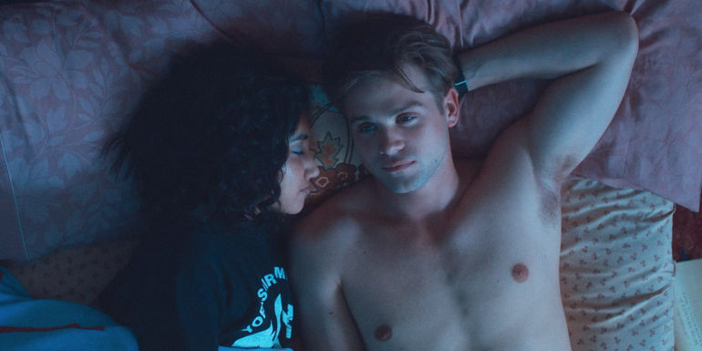 Emma and Dexter lie together in bed in One Day