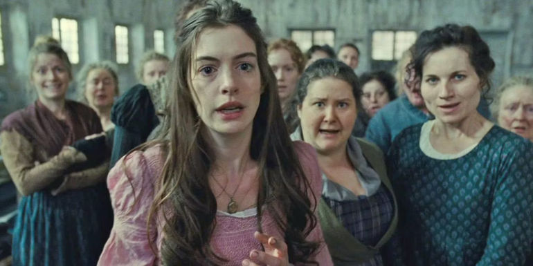 Fantine (Anne Hathaway) begging in Les Miserables.