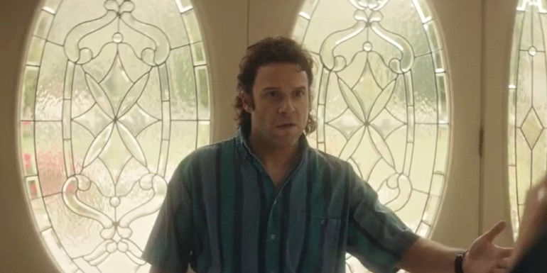 Rand Gauthier (Seth Rogen) standing by front doors and looking confused in in Pam & Tommy