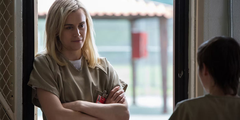 Piper (Taylor Schilling) leaning against a door in Orange is the New Black