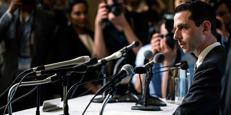 Kendall talks into microphones in Succession