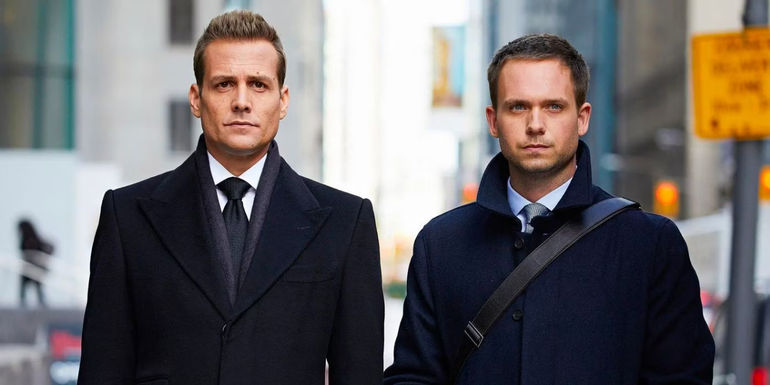 Harvey and Michael are standing together on a city street in Suits