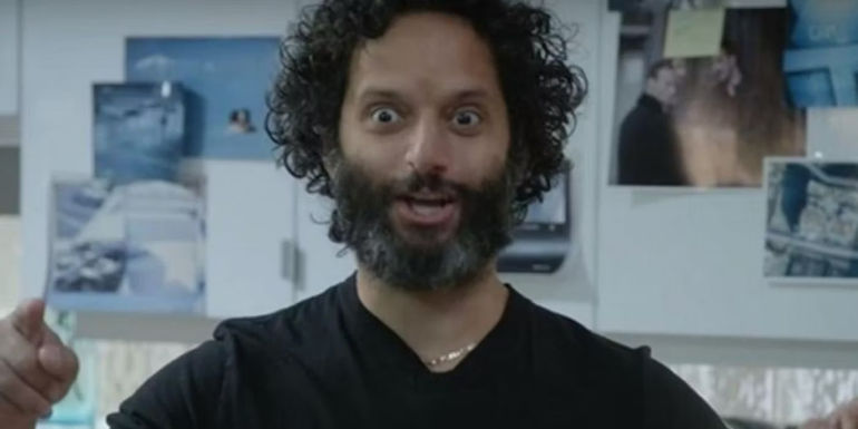 Pimento standing in front of a board of images in Brooklyn Nine-Nine