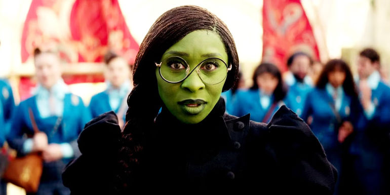 Cynthia Erivo as Elphaba looking ahead in a black dress in Wicked