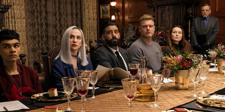 The Usher family sits at the dinner table.