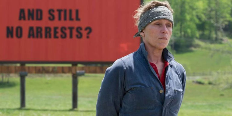 Frances McDormand stands by a billboard that reads 
