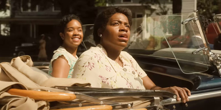 A stunned Celie (Fantasia Barrino) sitting in a car next to Squeak (H.E.R.) in The Color Purple (2023).