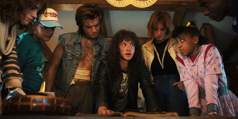 Nancy Dustin Steve Eddie Robin and Erica around a book in Stranger Things season 4