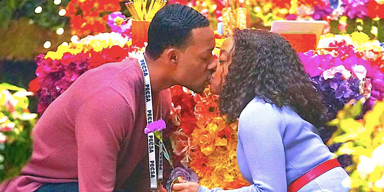 Quinta Brunson's Janine and Tyler James Williams' Gregory kissing among flowers in Abbott Elementary