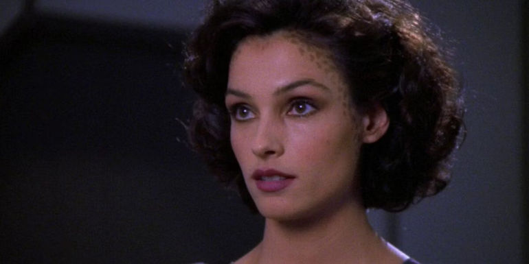 Kamala (Famke Janssen) talking with Captain Picard aboard the Enterprise