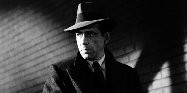 Humphrey Bogart standing in the shadows in The Maltese Falcon