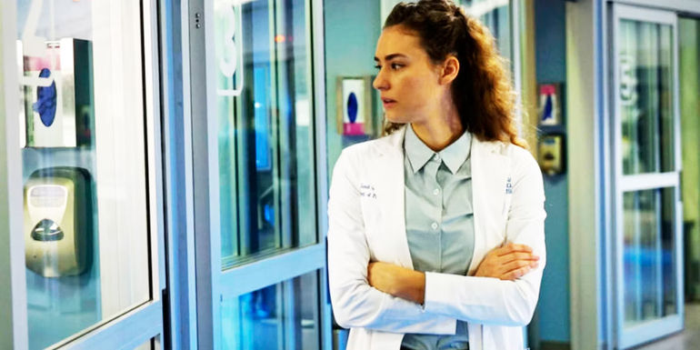 Rachel DiPillo with her arms crossed in the hospital in Chicago Med