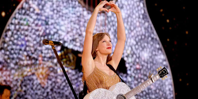 Taylor Swift making a hand heart during the eras tour