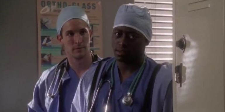 Dennis Grant standing in a doorway in ER