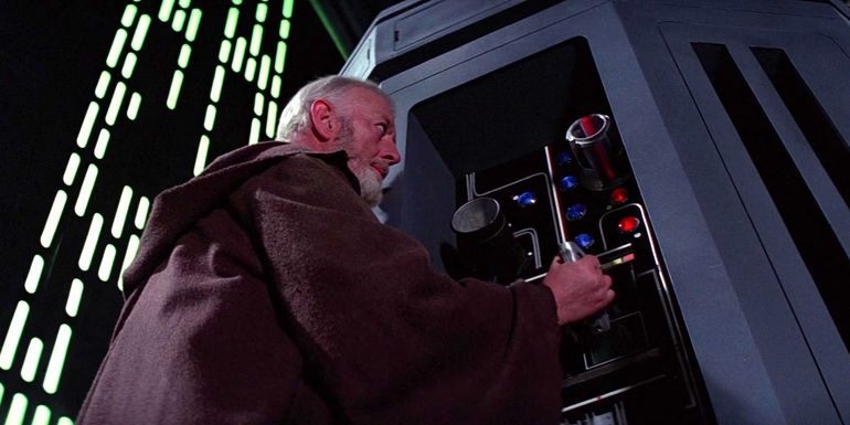 Obi-Wan Kenobi (Alec Guinness) adjust settings on the tractor beam in the Death Star in the original Star Wars