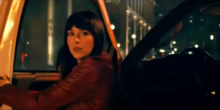 Cassandra Webb (Dakota Johnson) standing next to open ambulance in Madame Web trailer