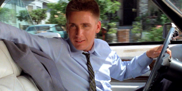 Emilio Estevez smiling while inside a car in Repo Man