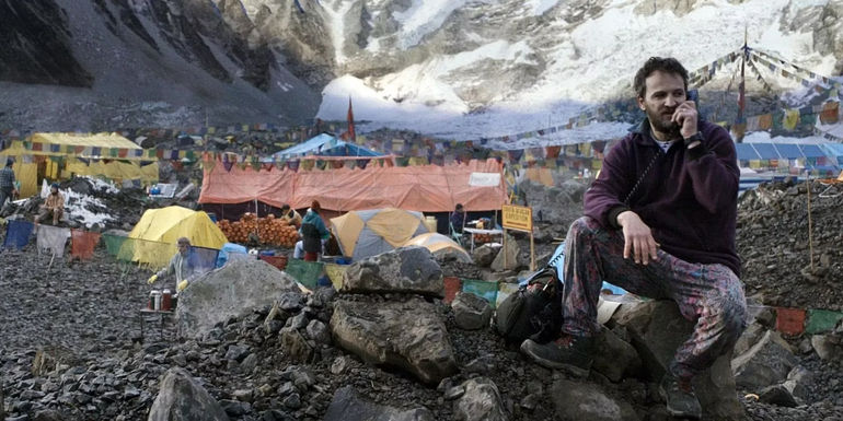 Jason Clarke as Rob Hall on his phone in a scene from Everest.