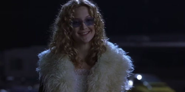 Penny Lane smiling while wearing sunglasses at night in Almost Famous