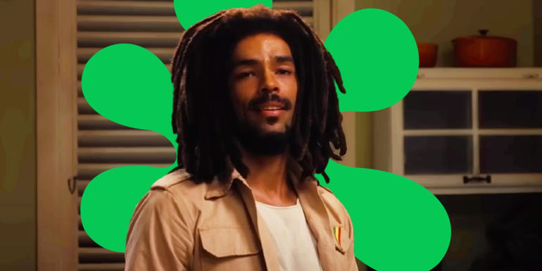 Kingsley Ben-Adir as Bob Marley in Bob Marley: One Love with a Rotten Tomatoes splat logo behind his head.