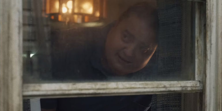 Brendan Fraser looking out the window in The Whale