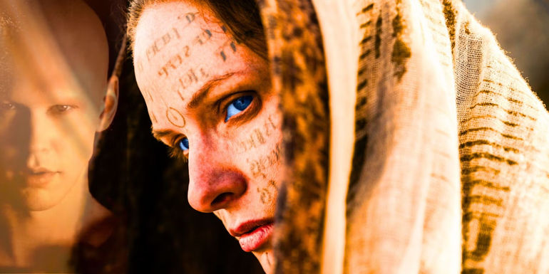 Rebecca Feguson's Lady Jessica as a Bene Gesserit reverend mother with Austin Butler's Feyd-Rautha Harkkonen in background from Dune 2