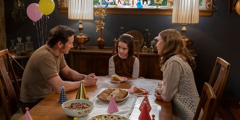 The Warren family sitting around a dining room table in the Conjuring Universe
