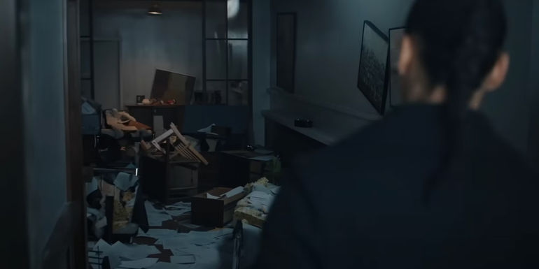 Neagley looks into a ransacked apartment in season 2 of Reacher