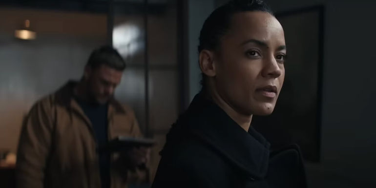 Neagley looks off into the distance as Reacher studies a photo in season 2