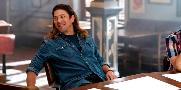 Christian Kane leaning back in a chair in Leverage Redemption