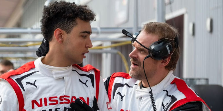 David Harbour as Jack Salter and Archie Madekwe as Jann Mardenboroughn in the pit lane in the Gran Turismo movie