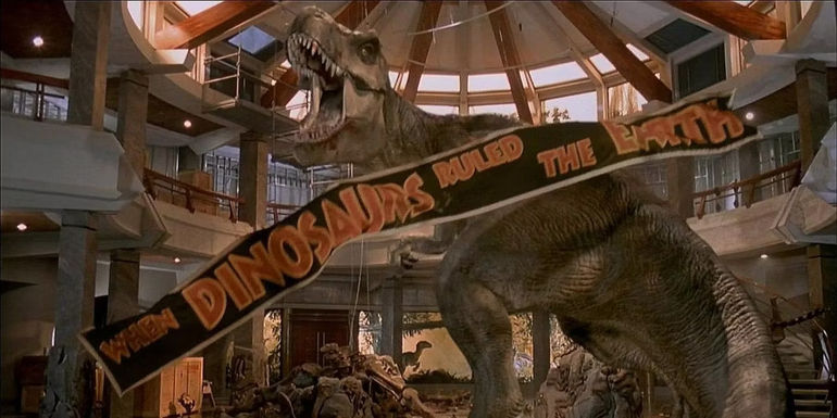 The T. Rex roaring in the visitor's center as a banner falls in Jurassic Park's ending