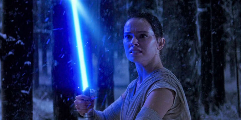 Rey wielding a lightsaber in Star Wars The Force Awakens