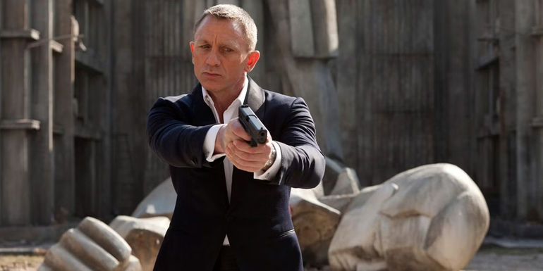 Daniel Craig as James Bond with a gun in Skyfall