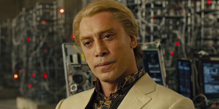 Javier Bardem as Raoul Silva siting and staring in Skyfall.