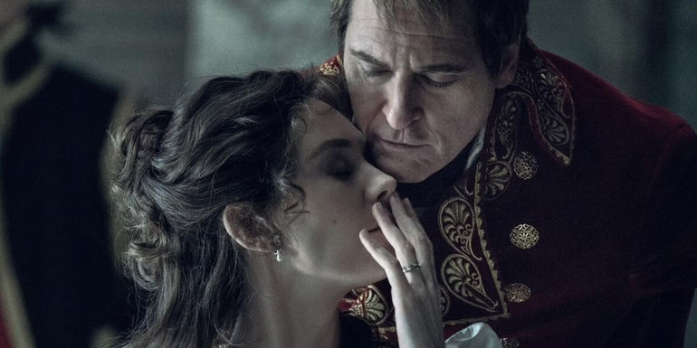 Vanessa Kirby whispers to Joaquin Phoenix in Napoleon