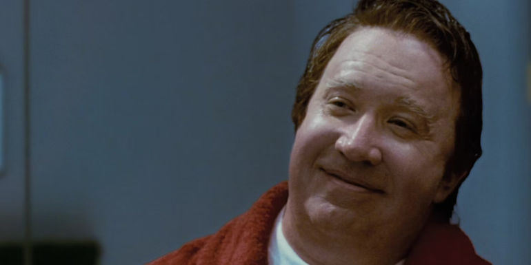 Scott Calvin smiling in the mirror in The Santa Clause