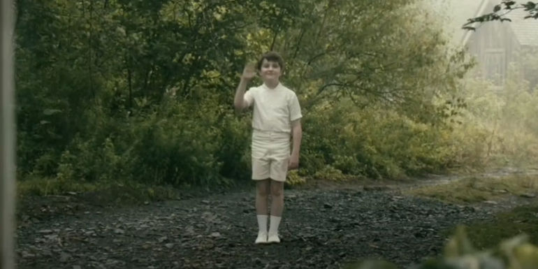 The Boy in White waving in From.