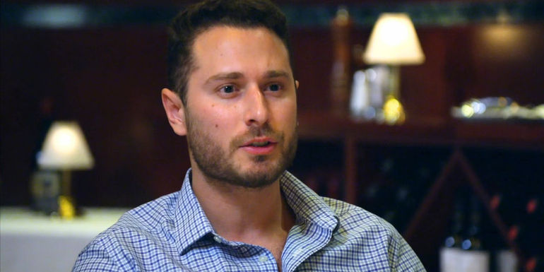 Brennan from Married at First Sight season 17 looking upset at dinner table