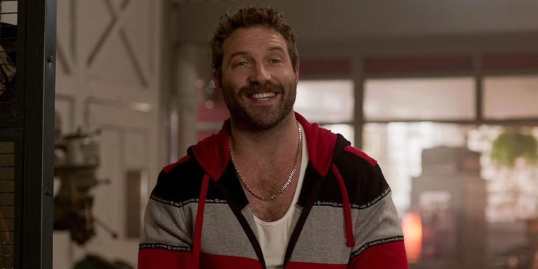 Jai Courtney smiles in Kaleidoscope 