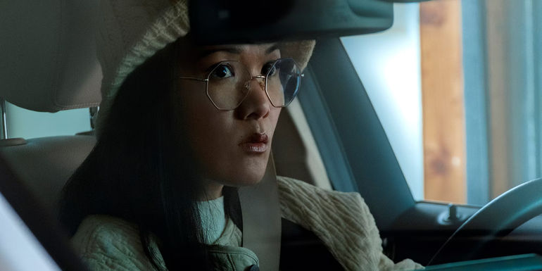 Amy (Ali Wong) looks concerned in her car in Beef