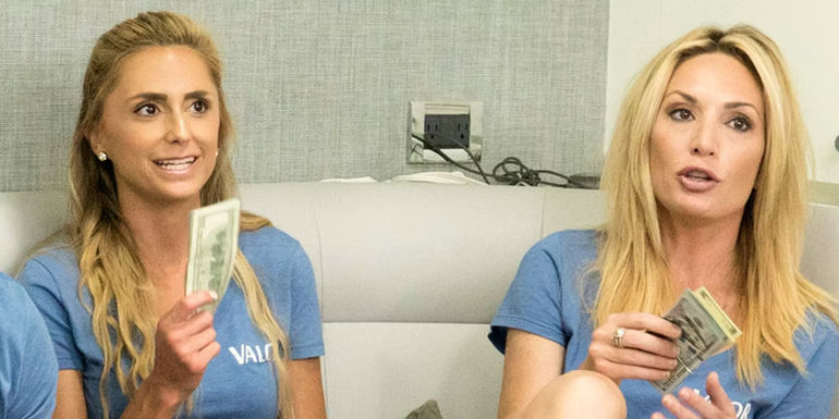 Kate and Jennifer talking while holding money on Below Deck.