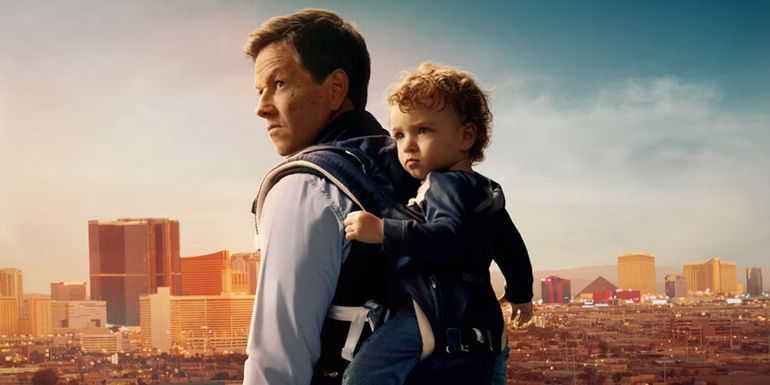 Dan with a baby on his back in The Family Plan