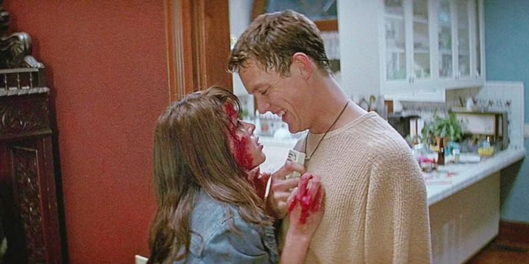 A bloody Sydney runs into a smiling Stu in his house in Scream.
