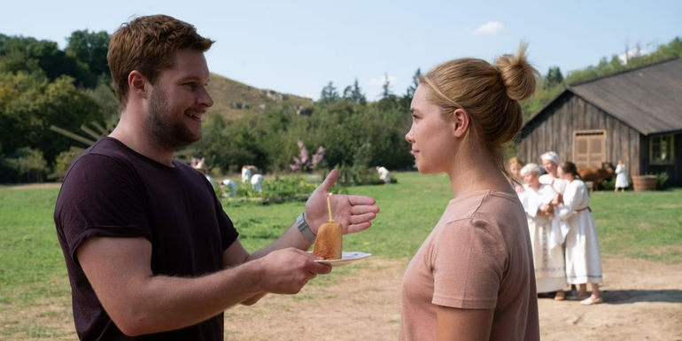 Christian (Jack Reynor) offering a slice of birthday cake to Dani (Florence Pugh) in Midsommar.