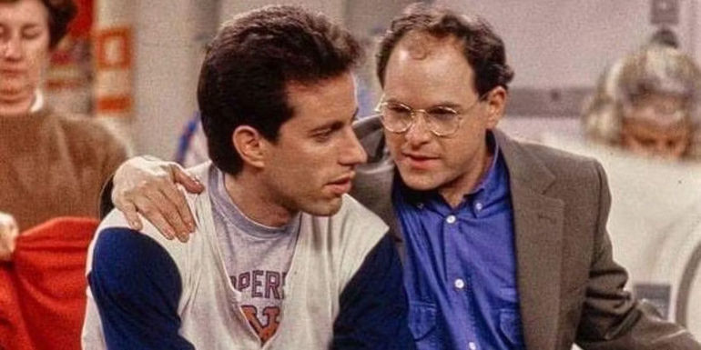 George with his arm around Jerry in laundromat