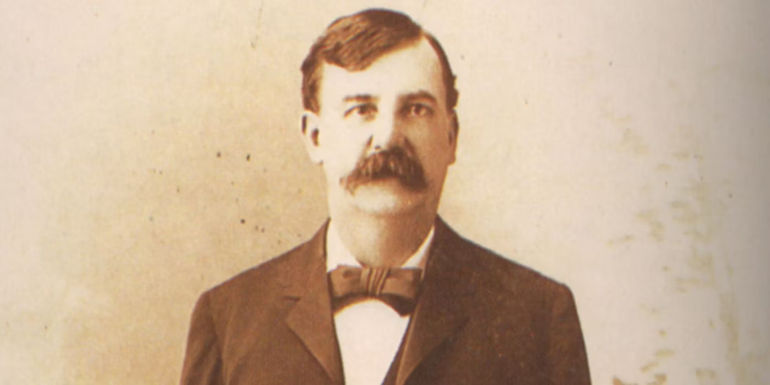 A 19th century photo of a front-facing Heck Thomas adorned in a nice suit, and sporting a well-groomed mustache